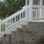 Side view of white railing on block stairs