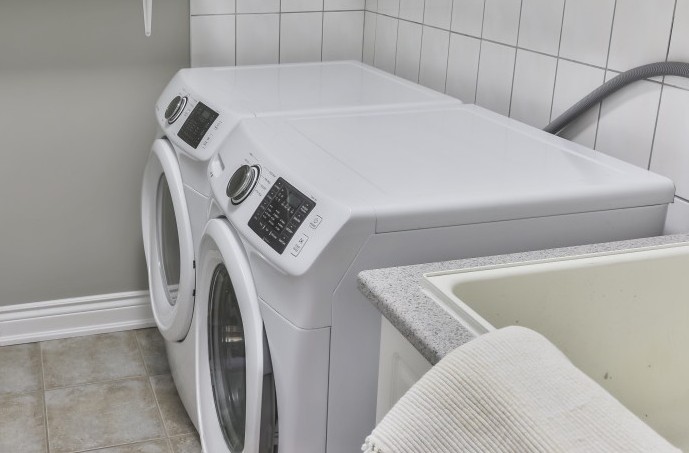A laundry room with a washer and dryer sitting side by side